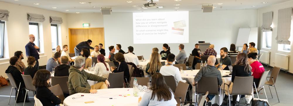 A room full of people participating in a workshop